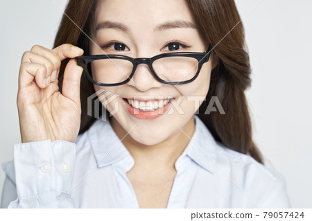 glasses, ophthalmology, young woman, business woman, career woman, nude, gray background glasses, ophthalmology, young woman, business woman, career woman, nude, gray background 79057424