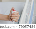 Close-up of patient hand pressing emergency button calling nurse in case of emergency in the hospital, patients need to help exigent, instant, pressing. 79057484