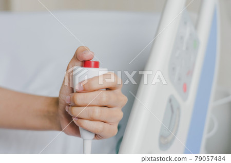 Close-up of patient hand pressing emergency button calling nurse in case of emergency in the hospital, patients need to help exigent, instant, pressing. 79057484