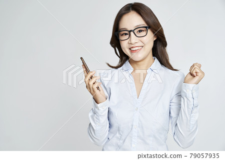 Glasses, smartphone, young woman, business woman, career woman, nude, gray background 79057935