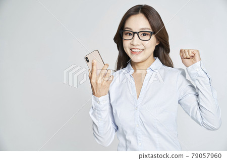 Glasses, smartphone, young woman, business woman, career woman, nude, gray background 79057960