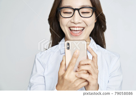 Glasses, smartphone, young woman, business woman, career woman, nude, gray background Glasses, smartphone, young woman, business woman, career woman, nude, gray background 79058086