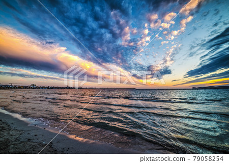 Colorful clouds over the sea at sunse Colorful clouds over the sea at sunse 79058254