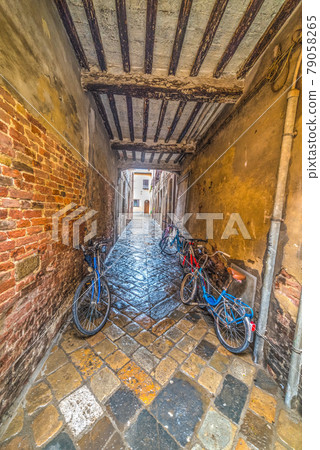 Bikes in a stone underpass 79058265