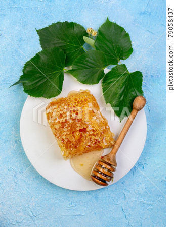 Lime honey in honeycombs. Lime honey in honeycombs. 79058437