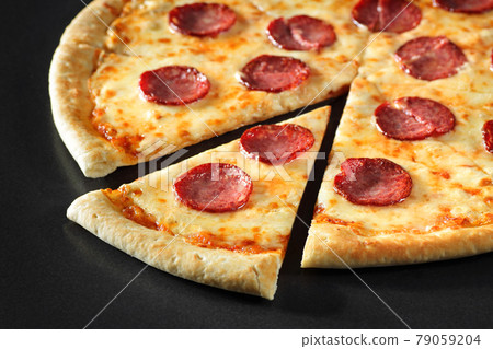 cut Pizza close up peperoni on black stone background cut Pizza close up peperoni on black stone background 79059204