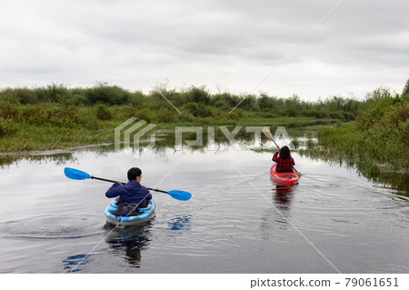 Adventure Friends Kayaking in Kayak surrounded by Canadian Mountain Landscape 79061651
