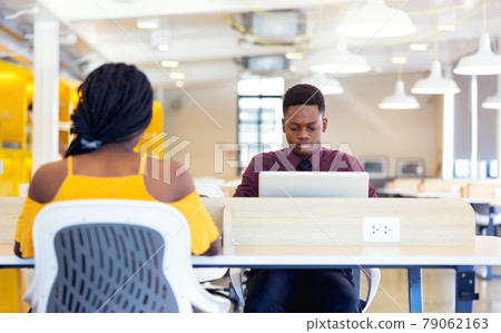 Portrait of two black students with netbook sitting at home interior, african american using laptop computer for searching information and making booking Portrait of two black students with netbook sitting at home interior, african american using laptop computer for searching information and making booking 79062163