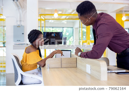 Portrait of two black students with netbook sitting at home interior, african american using laptop computer for searching information and making booking Portrait of two black students with netbook sitting at home interior, african american using laptop computer for searching information and making booking 79062164
