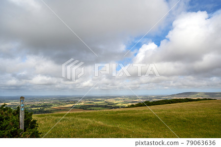 South Downs National Park, Sussex, UK near Firle Beacon. Signpost and views over the Weald seen from the South Downs Way. The South Downs Way is a national trail popular with walkers. 79063636