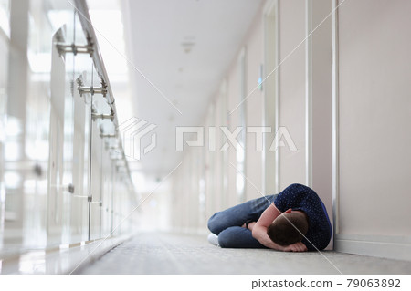 Young man sleeping under closed door of hotel room Young man sleeping under closed door of hotel room 79063892