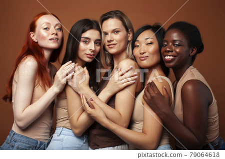 young pretty asian, caucasian, afro woman posing cheerful together on brown background, lifestyle diverse nationality people concept 79064618