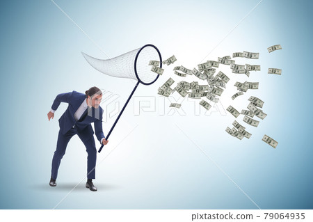 Young businessman catching dollars with landing net 79064935