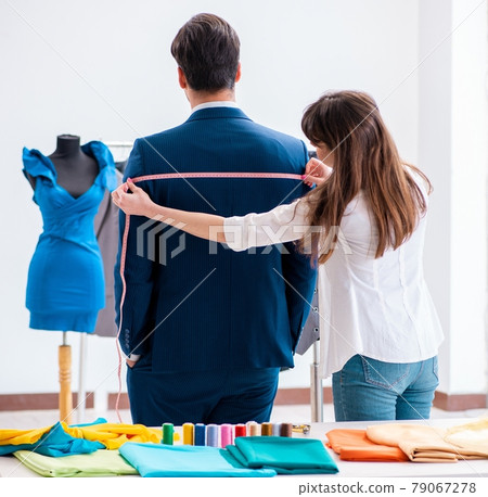 Professional tailor taking measurements for formal suit Professional tailor taking measurements for formal suit 79067278