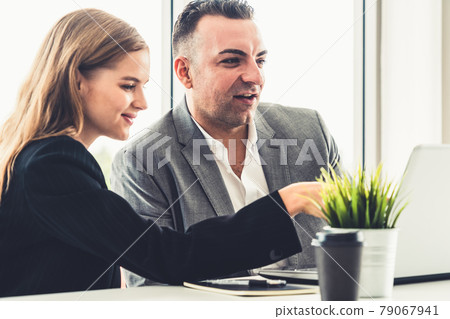 Businessman and businesswoman working in office. Businessman and businesswoman working in office. 79067941