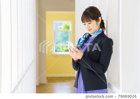 Business woman searching on a smartphone Business woman searching on a smartphone 79069026
