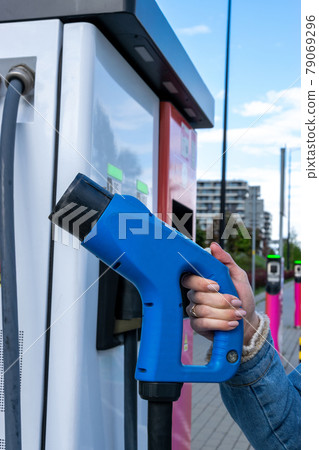Electric car charge. Power cable pump plug in eco green energy hybrid vehicle on future charger station. Recharge fuel technology with cable to power battery. Ecofriendly sustainable energy concept. Electric car charge. Power cable pump plug in eco green energy hybrid vehicle on future charger station. Recharge fuel technology with cable to power battery. Ecofriendly sustainable energy concept. 79069296