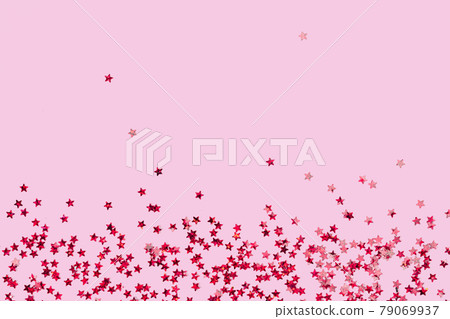 Red holographic star glitter confetti background on pink Red holographic star glitter confetti background on pink 79069937