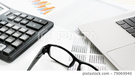 Finance. calculator on financial graphs on desk Finance. calculator on financial graphs on desk 79069940