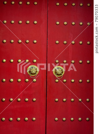 Red door with lion heads in asian style. Red door with lion heads in asian style. 79070333
