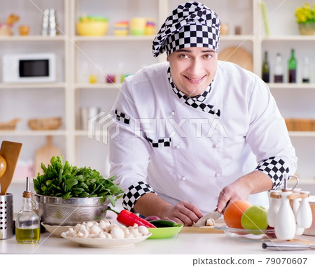 Young male cook working in the kitchen Young male cook working in the kitchen 79070607
