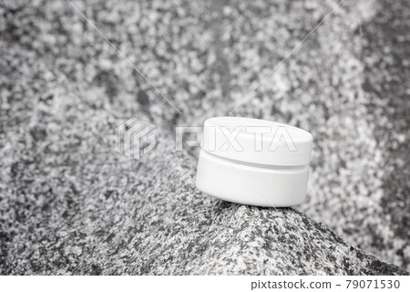 Hand cream, moisturizer, lotion in white plastic jar on grey stone front view. Anti aging cosmetic product template, luxury body care and organic science concept 79071530