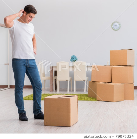 Man caryying boxes at home 79075324