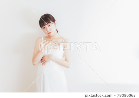 Young woman self-diagnosing breast cancer Young woman self-diagnosing breast cancer 79080062
