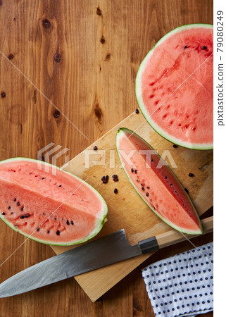 Cut watermelon on a cutting board 79080249