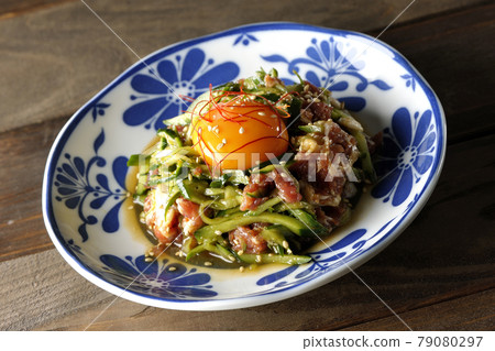 Yukhoe of cucumber and prosciutto with egg yolk, red pepper and sesame seeds 79080297