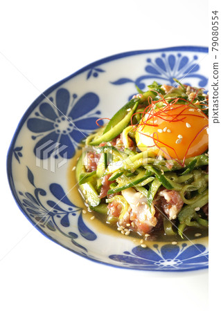 Photographed cucumber and prosciutto ham with egg yolk, red pepper and sesame seeds on a white background 79080554
