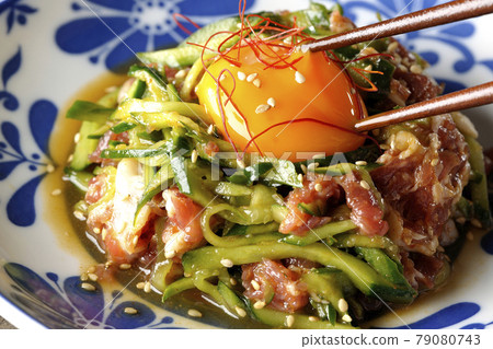 Cucumber with red pepper and sesame seeds and egg yolk on prosciutto ham 79080743