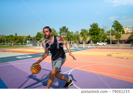 basketball player runs on a basketball court with a ball 79081255