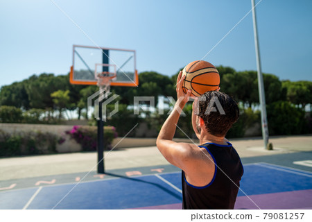 Male sportsman playing basketball throwing the ball at playgroun Male sportsman playing basketball throwing the ball at playgroun 79081257
