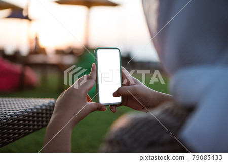Cropped shot view of woman's hands holding smart phone with blank copy space screen 79085433