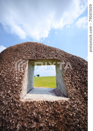 A small world cut out in a stone [blue sky and meadow] 79085609