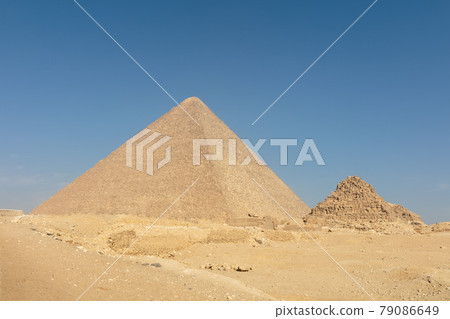 Big light pyramid in mysterious Egypt with the blue sky on the background. Big light pyramid in mysterious Egypt with the blue sky on the background. 79086649