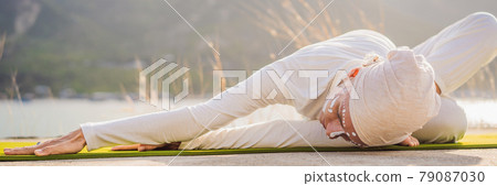 BANNER, LONG FORMAT Kundalini yoga woman in white clothes and turban practices yoga kundalini on the background of the sea, mountains and sunset. Fighting face painting of the Indians shows her inner BANNER, LONG FORMAT Kundalini yoga woman in white clothes and turban practices yoga kundalini on the background of the sea, mountains and sunset. Fighting face painting of the Indians shows her inner 79087030