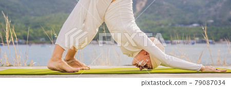 BANNER, LONG FORMAT Kundalini yoga woman in white clothes and turban practices yoga kundalini on the background of the sea, mountains and sunset. Fighting face painting of the Indians shows her inner BANNER, LONG FORMAT Kundalini yoga woman in white clothes and turban practices yoga kundalini on the background of the sea, mountains and sunset. Fighting face painting of the Indians shows her inner 79087034