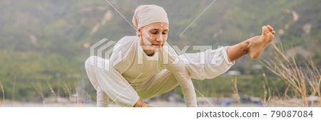 BANNER, LONG FORMAT Kundalini yoga woman in white clothes and turban practices yoga kundalini on the background of the sea, mountains and sunset. Fighting face painting of the Indians shows her inner BANNER, LONG FORMAT Kundalini yoga woman in white clothes and turban practices yoga kundalini on the background of the sea, mountains and sunset. Fighting face painting of the Indians shows her inner 79087084