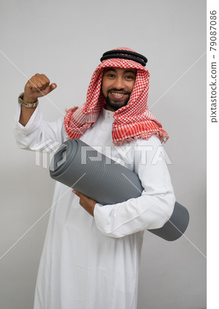 an arabian turban smiling excitedly while holding a roll of mattress and the other hand clenched up an arabian turban smiling excitedly while holding a roll of mattress and the other hand clenched up 79087086