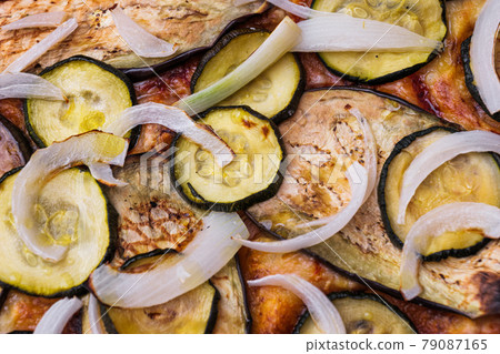 Close-up of pizza topped with grilled eggplant, zucchini and onion. Macro shot of delicious products. 79087165
