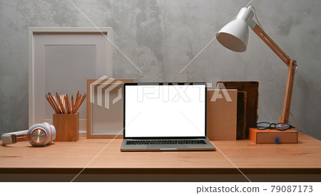Mock up computer laptop, empty frame, houseplant and pencil holder on wooden table. Mock up computer laptop, empty frame, houseplant and pencil holder on wooden table. 79087173
