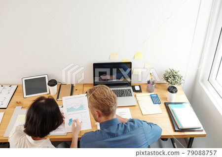 Business People Working with Reports Business People Working with Reports 79088757