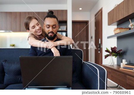 Woman Hugging Programming Husband Woman Hugging Programming Husband 79088961
