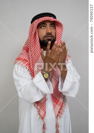 an arabic Muslim turban prays with both hands raised up an arabic Muslim turban prays with both hands raised up 79090337