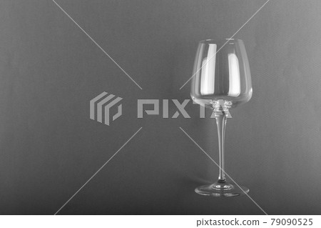 Empty glass of wine on a gray background. Empty glass of wine on a gray background. 79090525