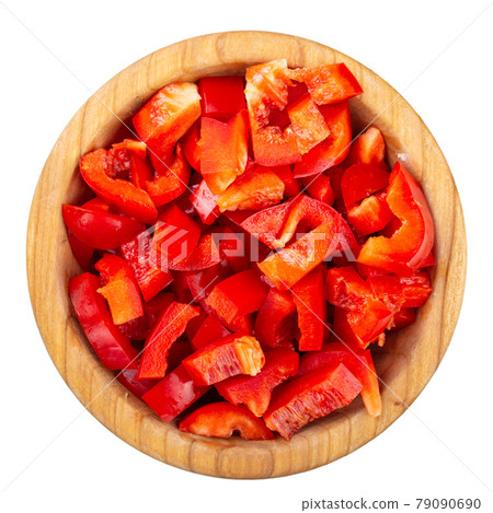 Sliced red bell pepper in a wooden bowl isolated on white background. Sliced red bell pepper in a wooden bowl isolated on white background. 79090690