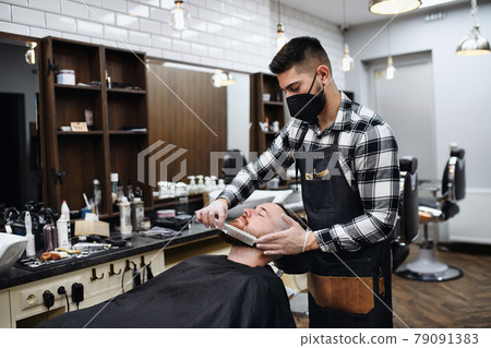 Man client visiting haidresser in barber shop, coronavirus and new normal concept. 79091383