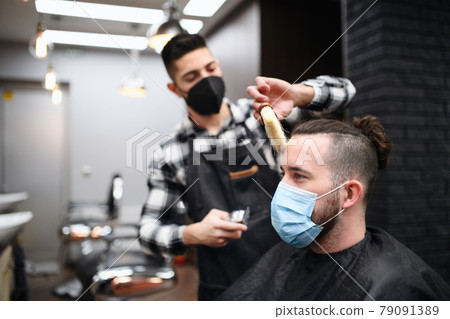 Man client visiting haidresser in barber shop, coronavirus and new normal concept. 79091389